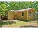 Cozy home exterior featuring wood siding, fenced yard, and a small deck at 4614 Ridge Dr, Pine Lake, GA 30072