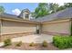 Charming home featuring siding and stone accents, complemented by a small patio and green bushes at 5336 Stone Village Nw Cir # 2, Kennesaw, GA 30152