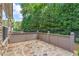 Private back patio featuring stone flooring, complemented by a neutral-stained privacy fence at 5336 Stone Village Nw Cir # 2, Kennesaw, GA 30152
