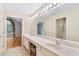 Bright primary bath with dual sink vanity, tile floor, and separate access to the shower and bedroom at 5336 Stone Village Nw Cir # 2, Kennesaw, GA 30152