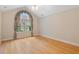 Bright bedroom featuring hardwood floors, vaulted ceiling and a large window with custom draperies at 5336 Stone Village Nw Cir # 2, Kennesaw, GA 30152