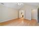 Bright bedroom featuring hardwood floors, vaulted ceiling, ceiling fan, and ensuite bathroom access at 5336 Stone Village Nw Cir # 2, Kennesaw, GA 30152