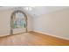 Bright bedroom featuring hardwood floors, vaulted ceiling and a large window with custom draperies at 5336 Stone Village Nw Cir # 2, Kennesaw, GA 30152