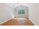 Bedroom with large window, ceiling fan, and hardwood floors at 5336 Stone Village Nw Cir # 2, Kennesaw, GA 30152