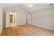 Bright bedroom featuring hardwood floors, vaulted ceiling, ceiling fan, and ensuite bathroom access at 5336 Stone Village Nw Cir # 2, Kennesaw, GA 30152