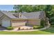 Exterior view showcasing the home's entrance with a charming outdoor patio at 5336 Stone Village Nw Cir # 2, Kennesaw, GA 30152