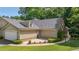 Attractive home featuring a stone facade, complemented by a garage, driveway, and well-manicured lawn at 5336 Stone Village Nw Cir # 2, Kennesaw, GA 30152