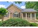 Attractive home featuring a stone facade, complemented by green shutters and mature landscaping at 5336 Stone Village Nw Cir # 2, Kennesaw, GA 30152