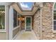 Charming front porch featuring stone accents, complemented by a dark-stained front door at 5336 Stone Village Nw Cir # 2, Kennesaw, GA 30152