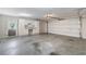 Spacious garage with concrete floors, overhead door and side door, along with built in cabinets and workstation at 5336 Stone Village Nw Cir # 2, Kennesaw, GA 30152