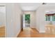 Hallway leading to a backyard view, featuring hardwood floors and neutral paint at 5336 Stone Village Nw Cir # 2, Kennesaw, GA 30152