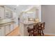 Charming kitchen featuring granite countertops, breakfast bar, and white appliances, perfect for Gathering meals at 5336 Stone Village Nw Cir # 2, Kennesaw, GA 30152
