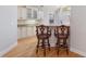Open kitchen with breakfast bar, white cabinetry, granite countertops, and stainless steel appliances at 5336 Stone Village Nw Cir # 2, Kennesaw, GA 30152