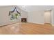 Spacious living room featuring hardwood floors, fireplace, and large windows at 5336 Stone Village Nw Cir # 2, Kennesaw, GA 30152