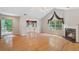 Bright living room featuring hardwood floors, a fireplace, and a sunroom, creating a warm and inviting space at 5336 Stone Village Nw Cir # 2, Kennesaw, GA 30152