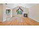 Open-concept living room with fireplace, hardwood floors, and bright natural light at 5336 Stone Village Nw Cir # 2, Kennesaw, GA 30152