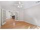 Open living room with hardwood floors, ceiling fan, and view of kitchen at 5336 Stone Village Nw Cir # 2, Kennesaw, GA 30152