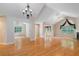 Open concept living room with cathedral ceiling, gleaming hardwood floors and large windows with custom draperies at 5336 Stone Village Nw Cir # 2, Kennesaw, GA 30152