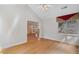 Open-concept living room featuring hardwood floors, a fireplace, and a view into the kitchen, enhancing the flow at 5336 Stone Village Nw Cir # 2, Kennesaw, GA 30152