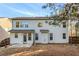 Back exterior of the house showing siding, windows, and a small patio, with privacy provided by mature trees at 121 Royal Sunset Dr, Dallas, GA 30157