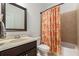 Bathroom with a shower-tub combo, floral shower curtain, and a vanity with a framed mirror at 121 Royal Sunset Dr, Dallas, GA 30157