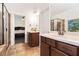 Bright bathroom featuring dual vanities, a glass-enclosed shower, and a view into the connected bedroom at 121 Royal Sunset Dr, Dallas, GA 30157