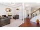 Bright foyer featuring hardwood floors, a staircase with wooden banister, and neutral-toned walls with decorative accents at 121 Royal Sunset Dr, Dallas, GA 30157