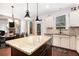 Bright eat-in kitchen featuring an island with granite countertops, stainless steel appliances, and wooden floors at 121 Royal Sunset Dr, Dallas, GA 30157