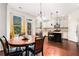 Bright eat-in kitchen featuring an island with granite countertops, stainless steel appliances, and wooden floors at 121 Royal Sunset Dr, Dallas, GA 30157