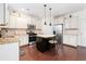 Bright eat-in kitchen featuring white cabinets, granite countertops, stainless steel appliances, and an island with seating at 121 Royal Sunset Dr, Dallas, GA 30157