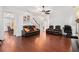 Spacious living room featuring hardwood floors, a ceiling fan, and comfortable seating arrangements at 121 Royal Sunset Dr, Dallas, GA 30157