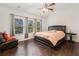 Bright main bedroom with a vaulted ceiling, dark wood floors, and abundant natural light at 121 Royal Sunset Dr, Dallas, GA 30157