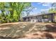 View of a newly seeded backyard and home's rear elevation with mature landscaping at 1995 Mcafee Rd, Decatur, GA 30032