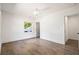Bright bedroom with hardwood floors, white trim, ceiling fan, and a window offering an abundance of natural light at 1995 Mcafee Rd, Decatur, GA 30032