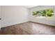 Bedroom featuring hardwood floors, a window, and white walls and trim at 1995 Mcafee Rd, Decatur, GA 30032