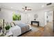 Inviting bedroom featuring hardwood floors, a ceiling fan, and ample natural light from the window at 1995 Mcafee Rd, Decatur, GA 30032