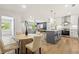 Open-concept kitchen with gray island, stainless appliances, and adjacent living area with lots of natural light at 1995 Mcafee Rd, Decatur, GA 30032