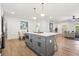 Open-concept kitchen with gray island and stainless steel appliances that connects to the living area at 1995 Mcafee Rd, Decatur, GA 30032