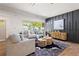 Stylish living room with hardwood floors, gray couches, and a designer accent wall at 1995 Mcafee Rd, Decatur, GA 30032