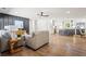 Open-concept living room with hardwood floors seamlessly transitioning to a modern white kitchen at 1995 Mcafee Rd, Decatur, GA 30032