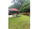 Well-maintained backyard with patio, landscaping, seating and lawnmower at 200 Birchwood Dr, Loganville, GA 30052