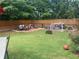Spacious backyard with a patio, lawn, and tall wooden fence at 200 Birchwood Dr, Loganville, GA 30052