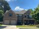 Charming two-story brick home featuring an attached two-car garage, covered porch and lush landscaping at 200 Birchwood Dr, Loganville, GA 30052