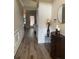 Hallway with paneled walls, hardwood floors, and elegant console table at 200 Birchwood Dr, Loganville, GA 30052