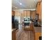 Modern kitchen with stainless steel appliances and wood cabinets at 200 Birchwood Dr, Loganville, GA 30052