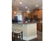 Open kitchen with a breakfast bar, wood cabinets, and pendant lights at 200 Birchwood Dr, Loganville, GA 30052
