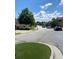 Residential street view with sidewalks, trees, and parked cars on a sunny day at 200 Birchwood Dr, Loganville, GA 30052