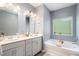 Bright bathroom with double vanity, soaking tub, and elegant fixtures at 2140 Ravencliff Dr, Austell, GA 30168