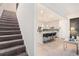 View from staircase, an open kitchen with modern island, stainless appliances, and sleek lighting at 2140 Ravencliff Dr, Austell, GA 30168