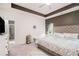 Comfortable main bedroom featuring a tray ceiling, en-suite bathroom, and neutral color palette at 2140 Ravencliff Dr, Austell, GA 30168
